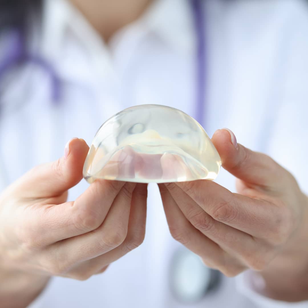 doctor holding breast implant
