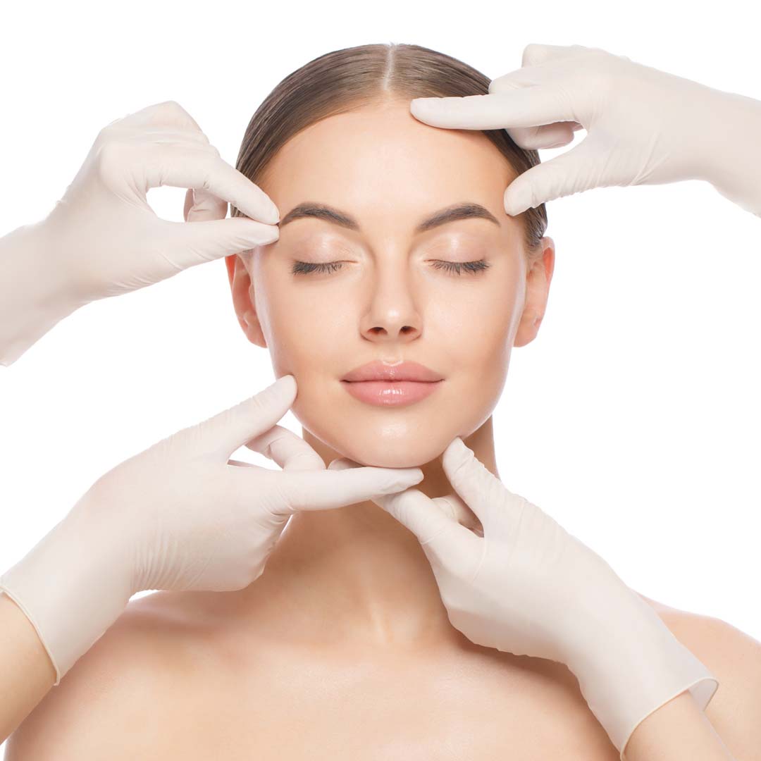 A woman has her eyes closed and different parts of her face are being touched by gloved hands