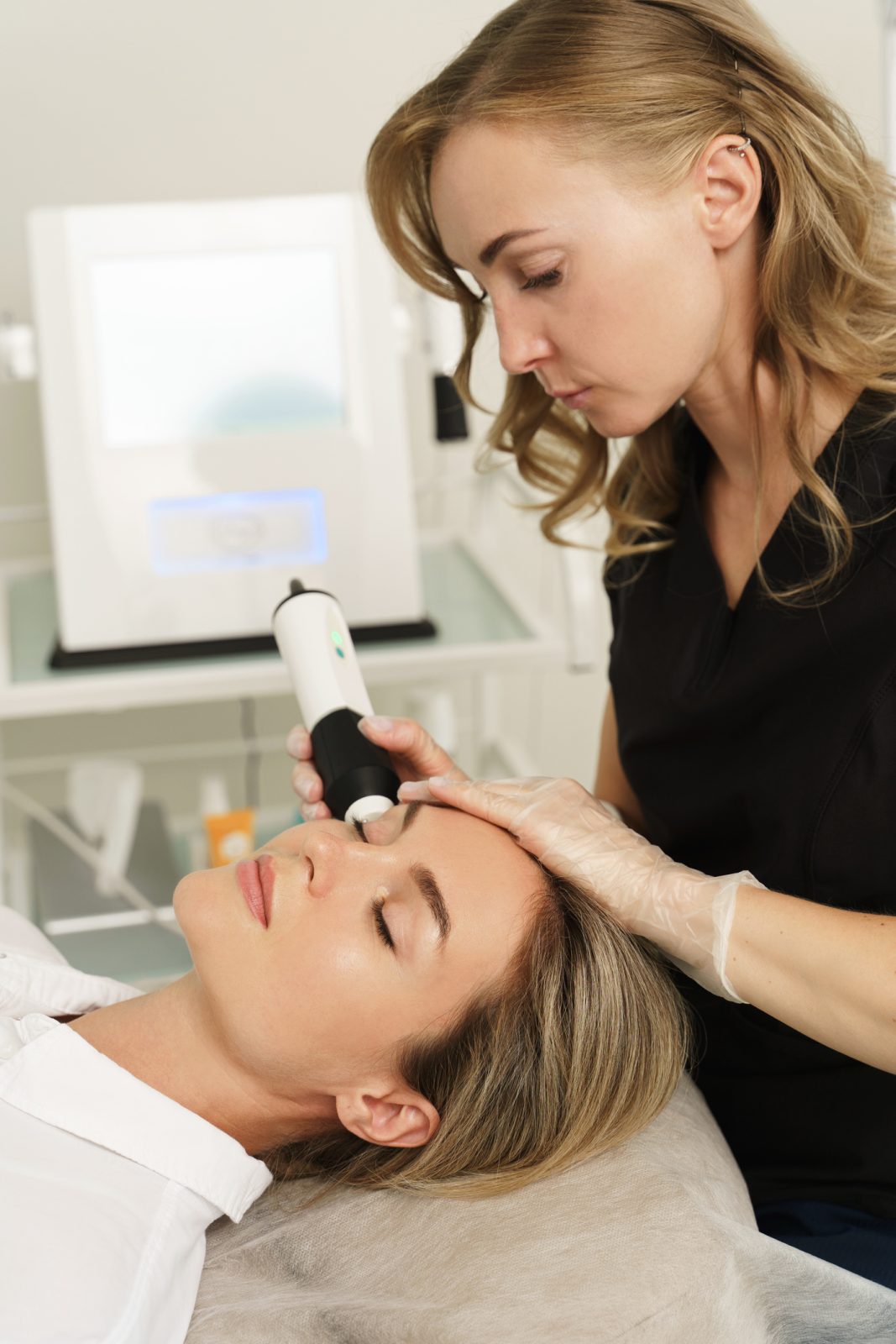 Woman during carbon dioxide laser resurfacing in a cosmetology clinic