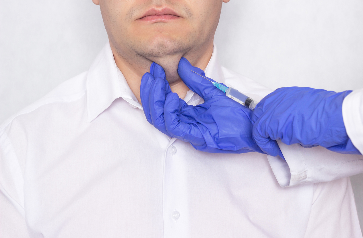 Doctor gives the patient double chin injections of hyaluronic acid, close-up, problems