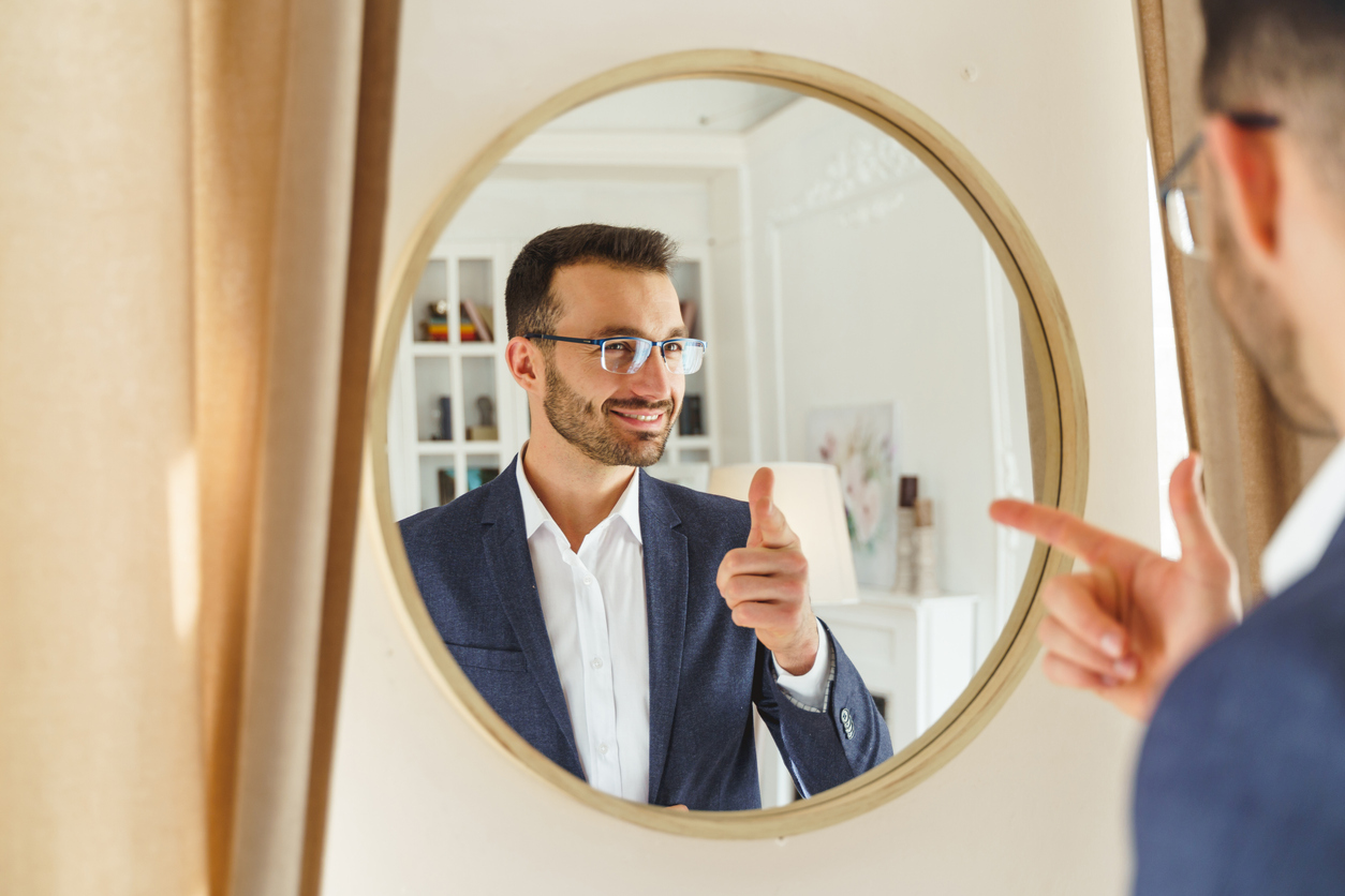 Pleased male wearing stylish suit and eyeglasses