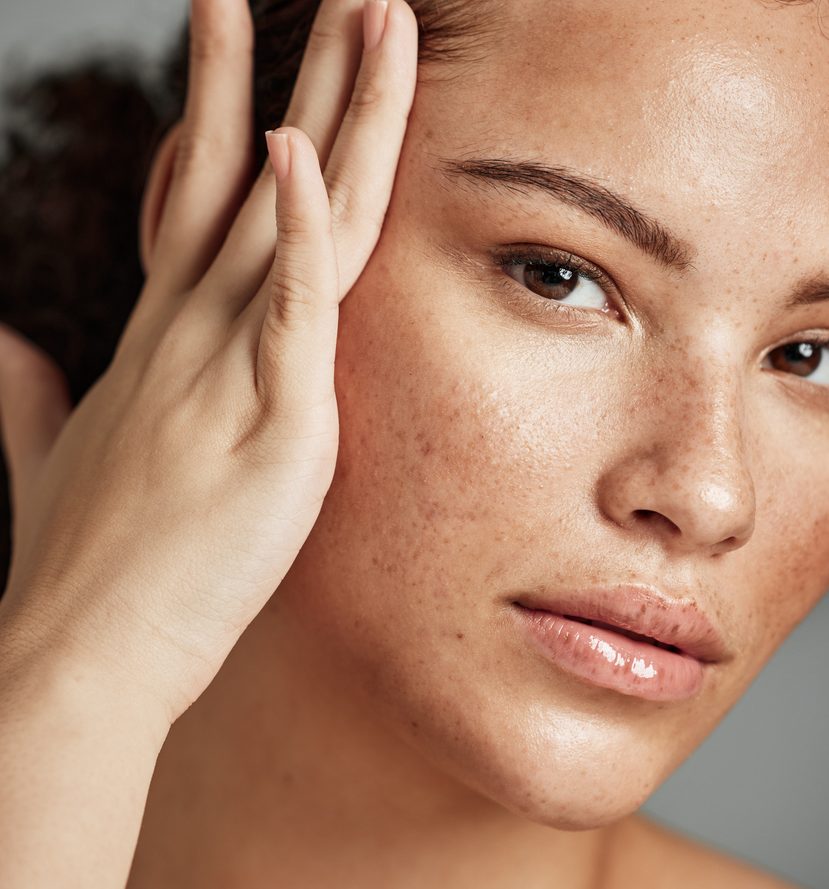 Skin, beauty and black woman portrait with skincare glow from spa treatment and makeup. Model, hand and face of a person relax after dermatology detox in a studio with gray background feeling healthy