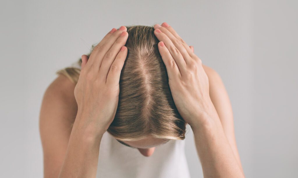Women's hair is a top view close-up.
