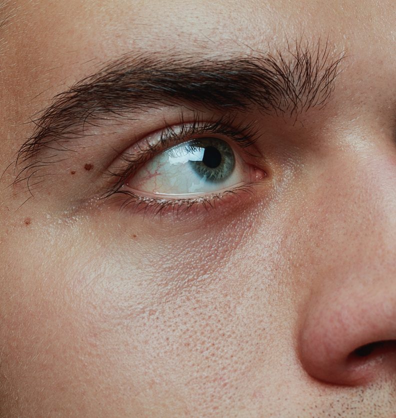 Close-up portrait of young man isolated on grey studio background