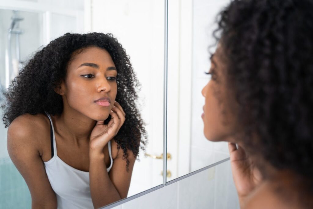 Young black woman taking care about her skin