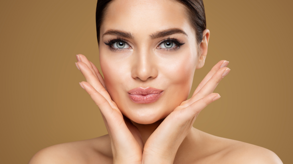 Beautiful woman with enhanced lips, hands framing face