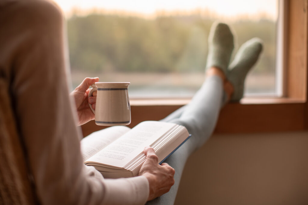 Person reading beside window