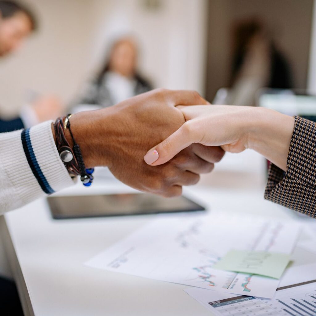 Man and woman shaking hands during a meeting