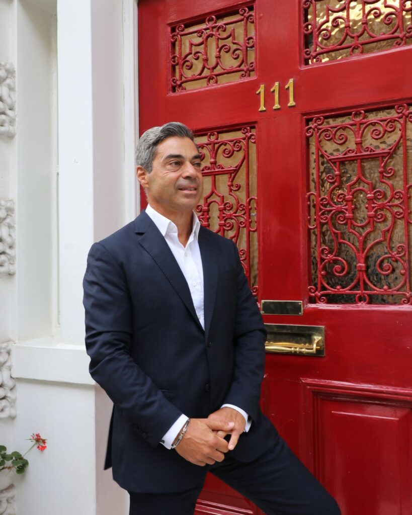 Dr Yannis Alexandrides smiling in front of 111Harley St clinic